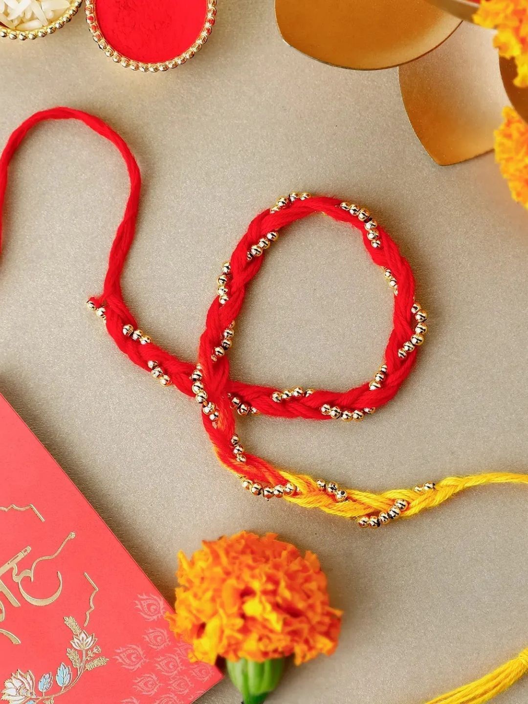 

fnp Sacred Beadwork Mauli Rakhi Traditional Kundan, Red