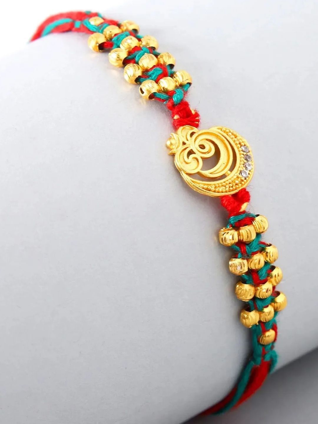 

fnp Divine Serenity Om Rakhi Bhaiya-Bhabhi Rakhis, Gold