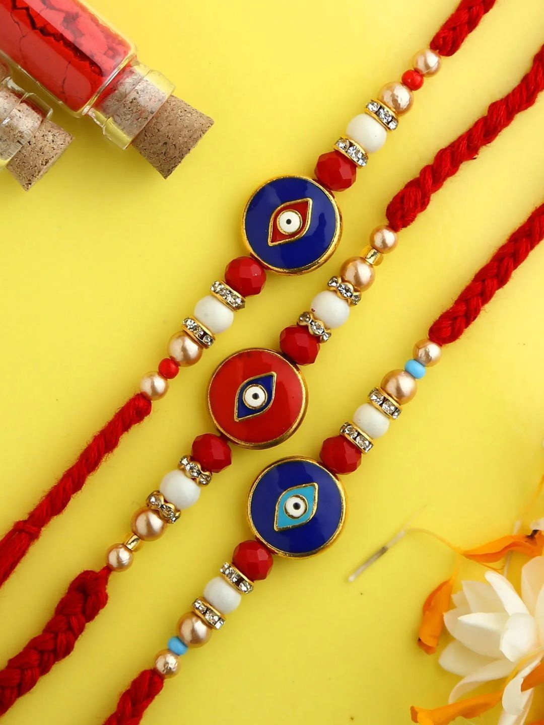 

fnp Evil Eye Rakhi Set Bhaiya-Bhabhi Rakhis, Red
