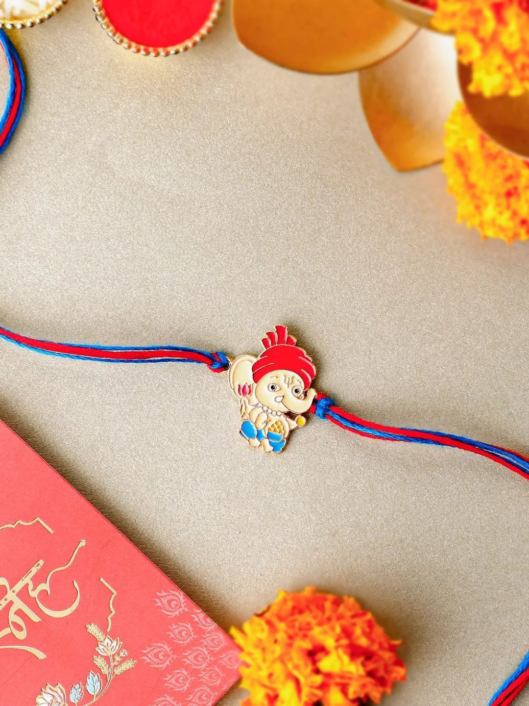 

fnp Radiant Ganesha Serenity Rakhi For Kids Mauli Rakhis, Red