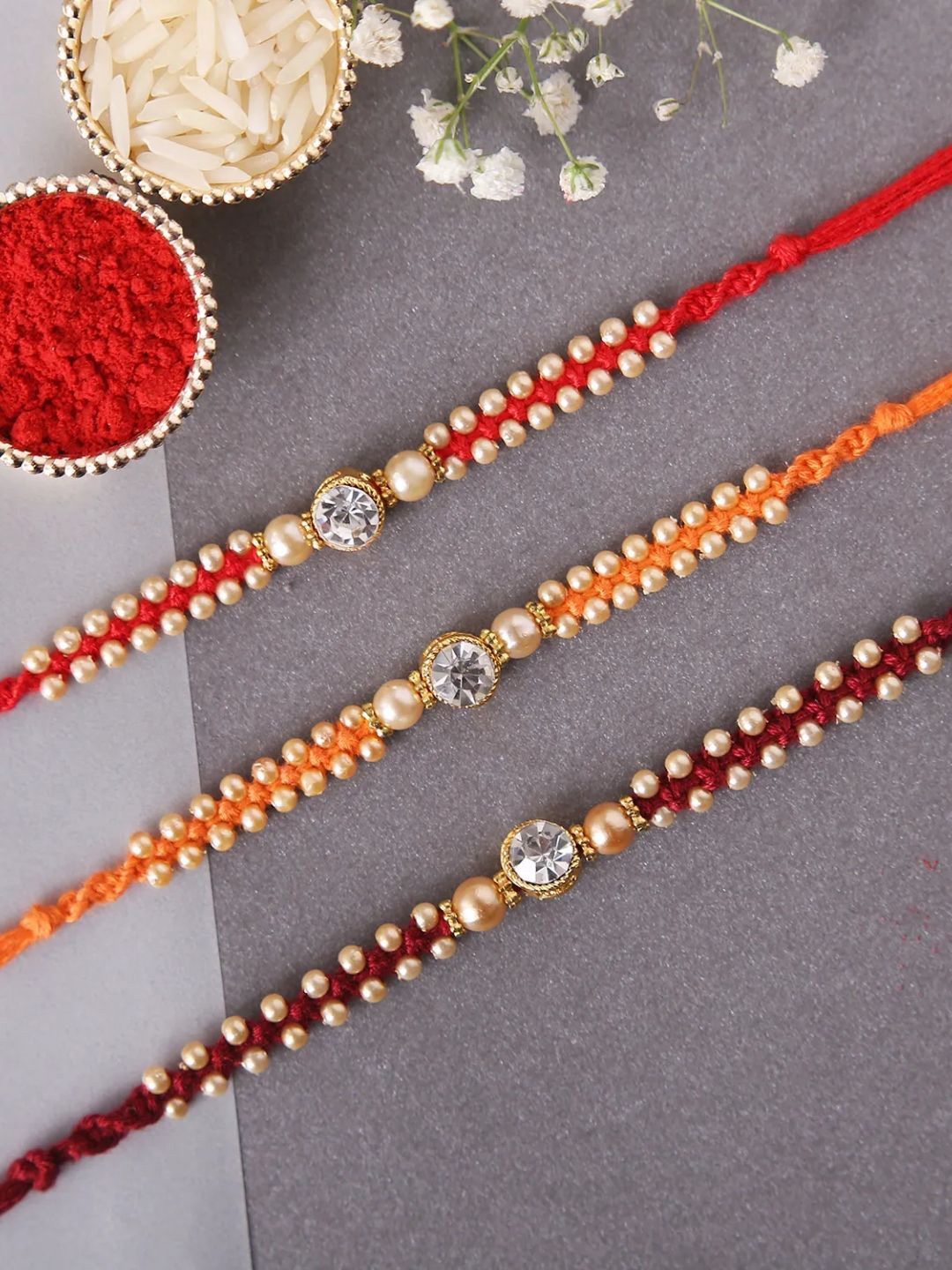 

fnp Sneh Stunning Diamond Rakhis Set of 3 Magical Evil Eye, Gold