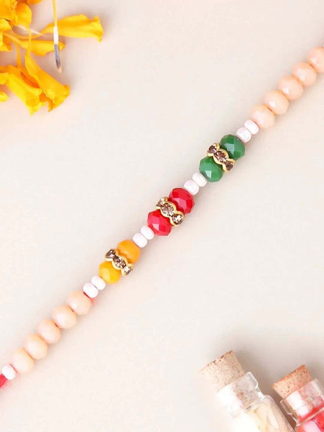 

fnp Serene Pearl Motif Rakhi Magical Evil Eye, Pink
