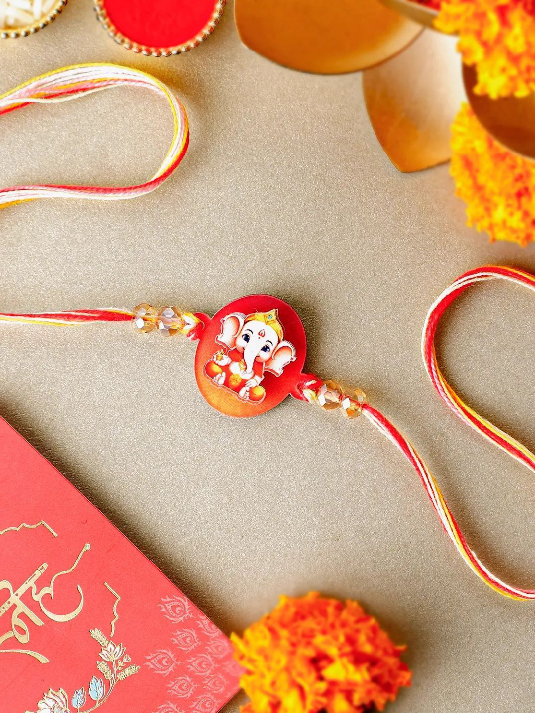 

fnp Sculpted Ganesha 3D Rakhi American Diamond, White