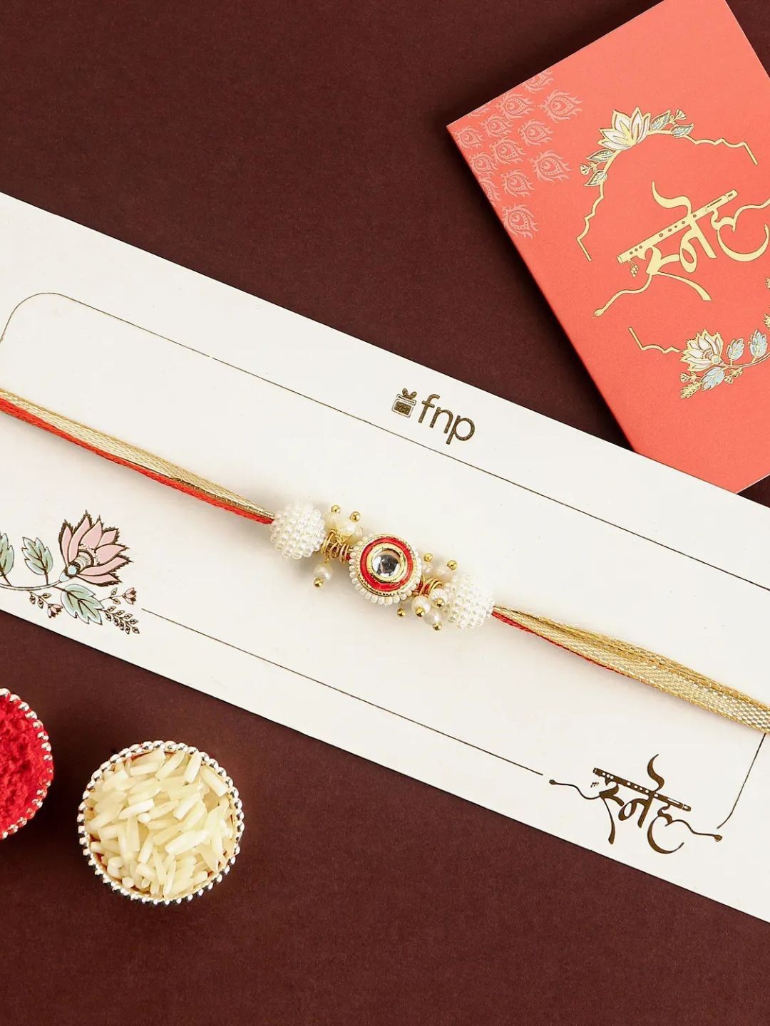 

fnp Crimson Majestic Pearl Rakhi Traditional Kundan, Gold