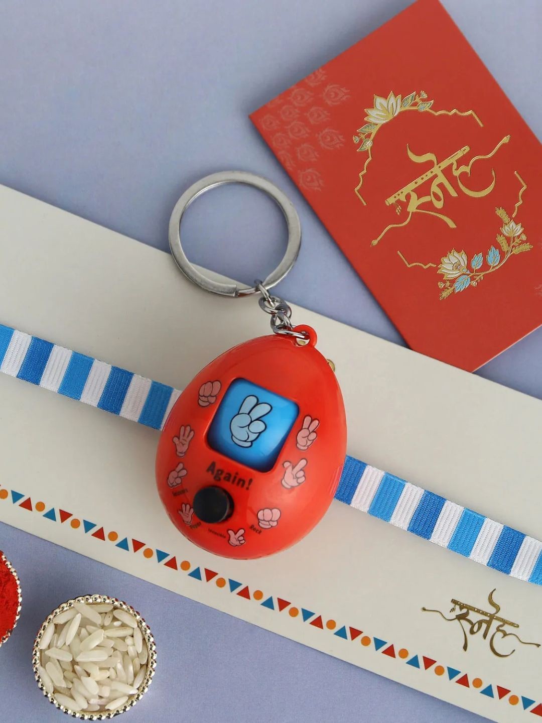 

fnp Playful Rock Paper Scissors Toy Rakhi American Diamond, Red