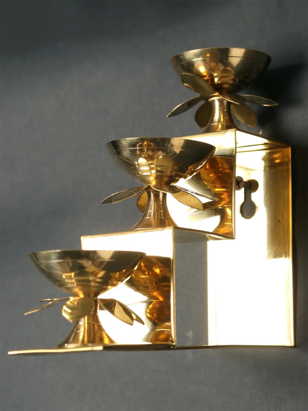 

Exotic India Set of 3 Brass Lamps on Steps Wall Hanging, Gold