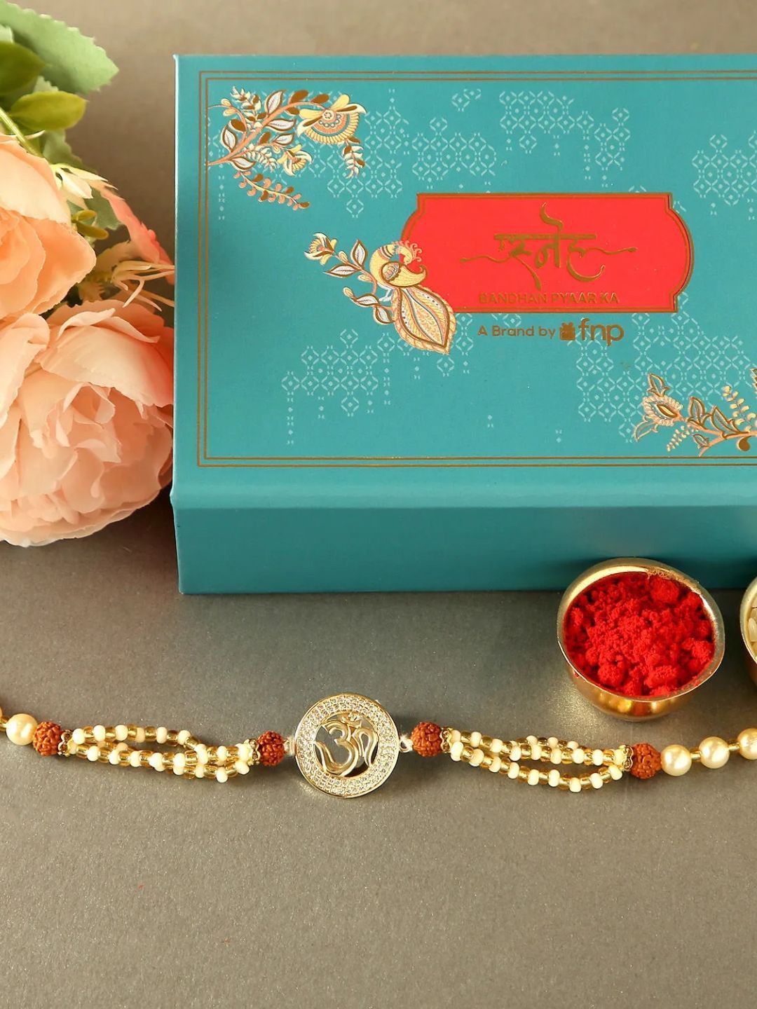 

fnp Twinkling Whispers of Divinity Om Rudraksha Rakhi Mauli Rakhis, Gold