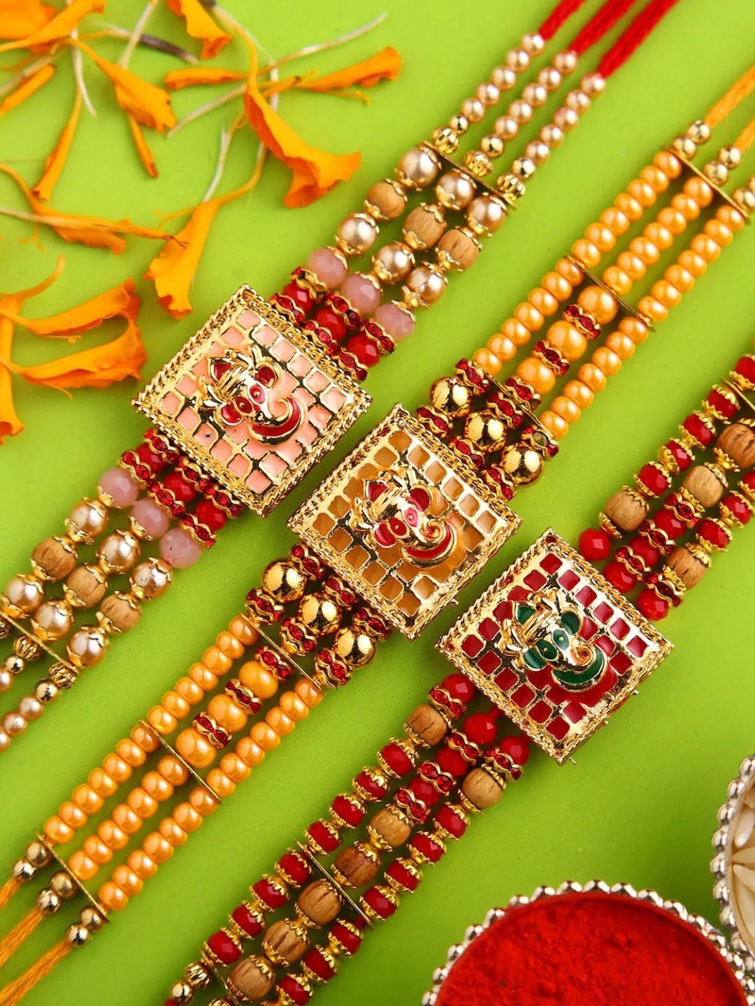 

fnp Enchantingly Ornate Meenakari Rakhi Set of 3 Bhaiya-Bhabhi Rakhis, Yellow