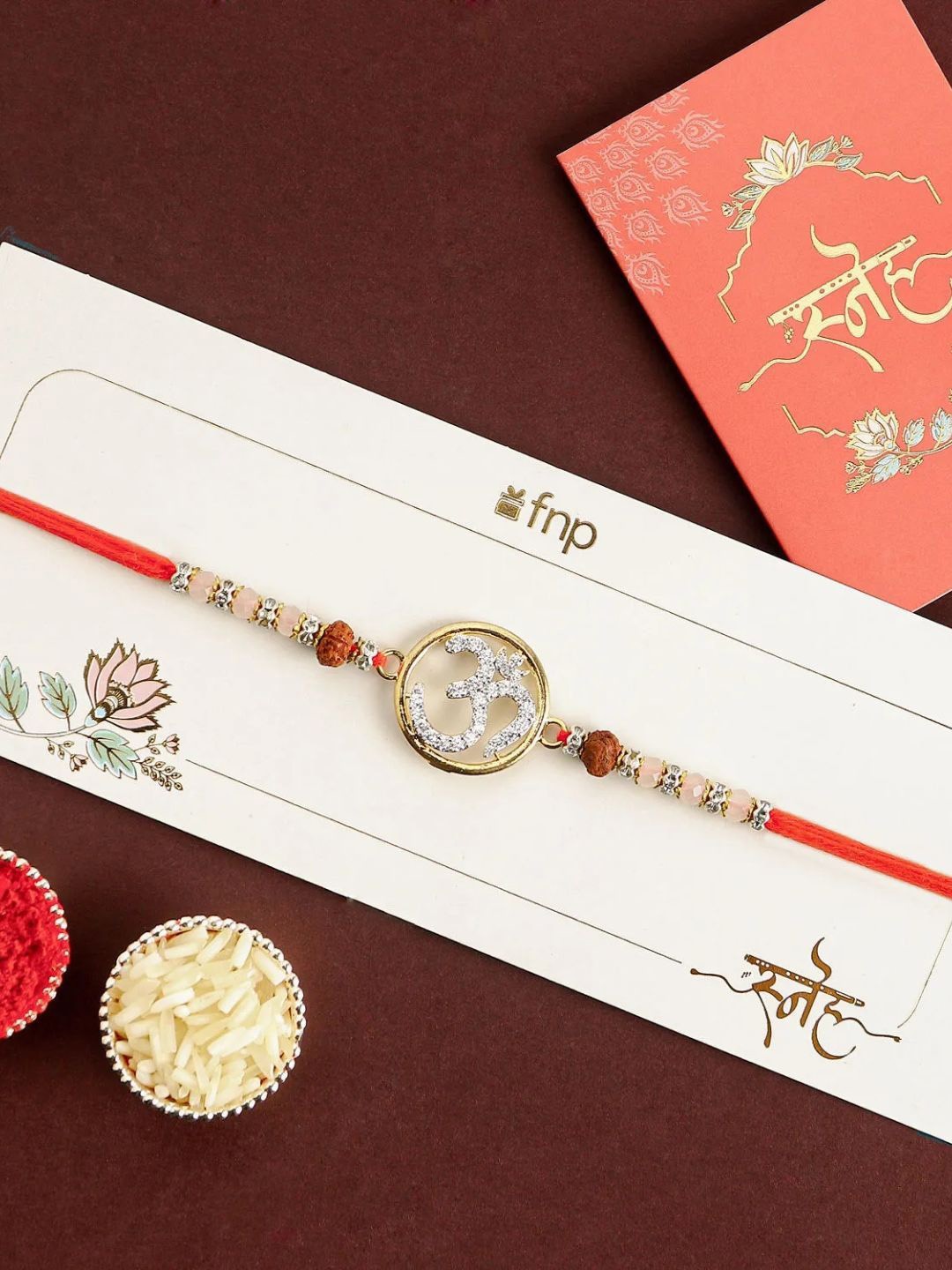 

fnp Eternal Glow Om Rakhi Bhaiya-Bhabhi Rakhis, Gold