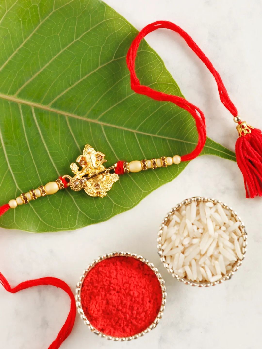 

fnp Sneh Cute Lord Ganesha Rakhi Kids Collection, Red