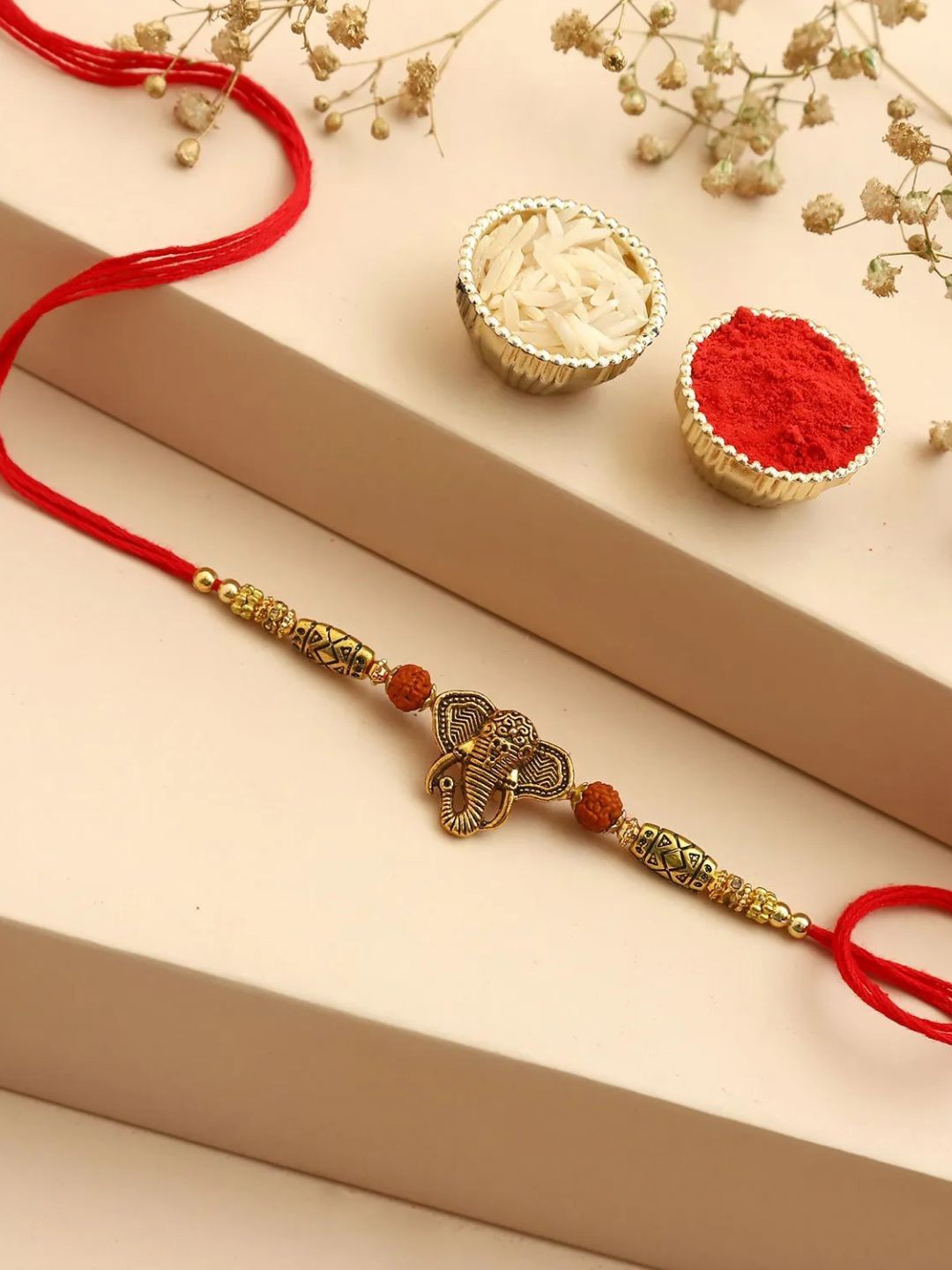 

fnp Ganeshas Gleaming Blessings Rudraksh Rakhi Classic Pearls, Gold