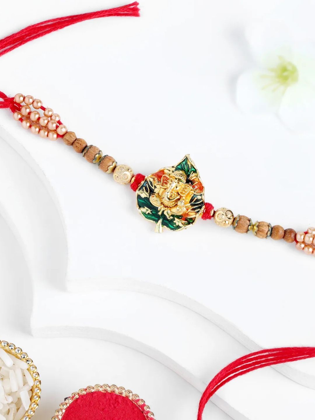 

fnp Aurora Ganesha Meenakari Rakhi American Diamond, Red