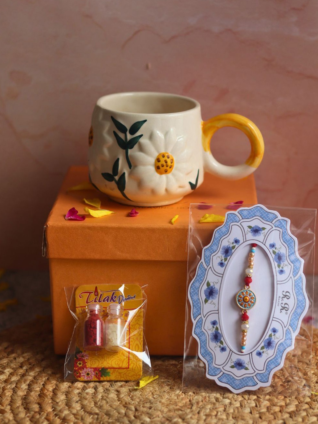 

WEAVING HOMES Rakhi With Daisy Mug & Roli Chawal, Gold