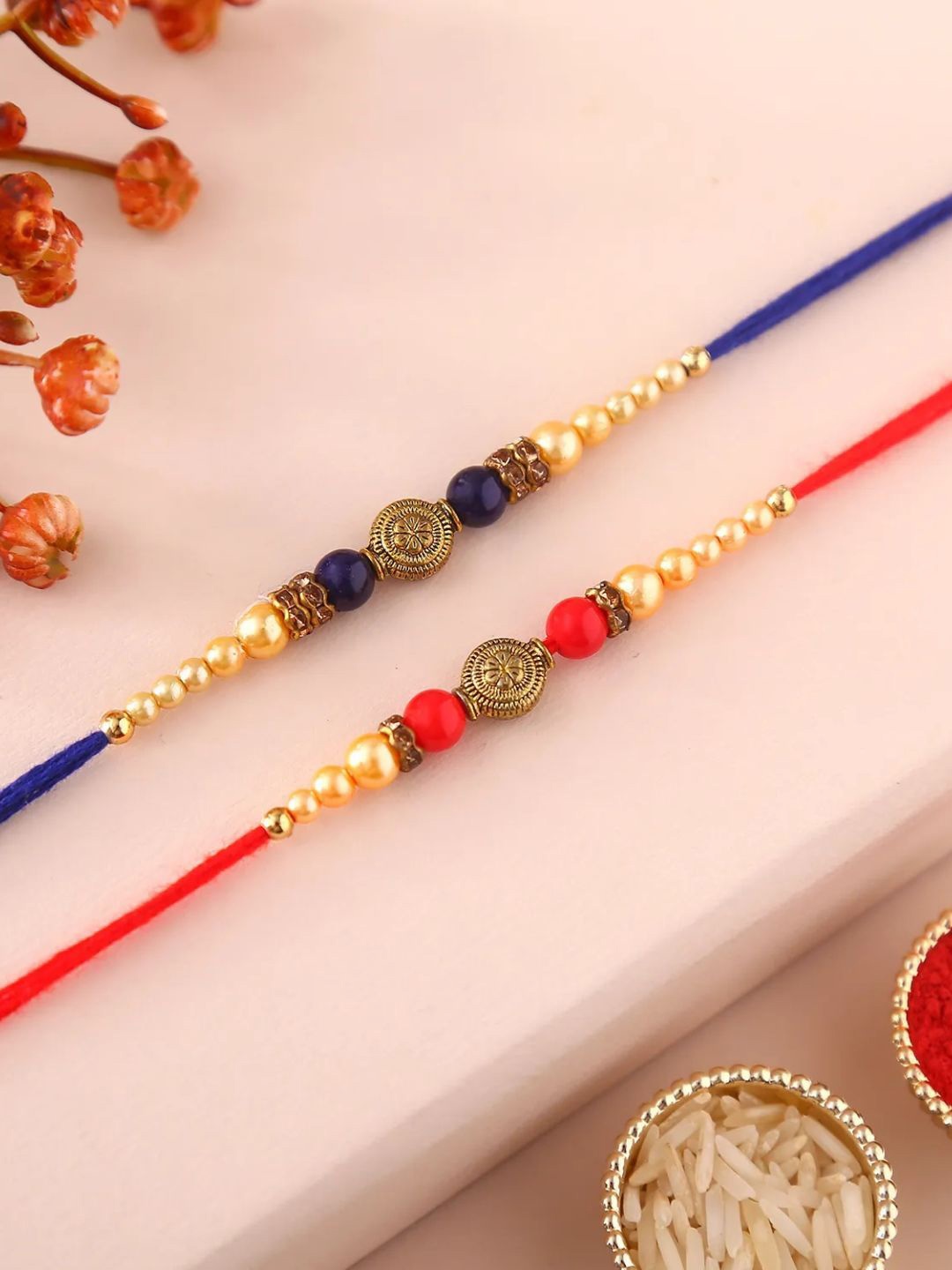 

fnp Sneh Ethnic Pearl Colourful Rakhis Set of 2 Lumba Rakhis, Red