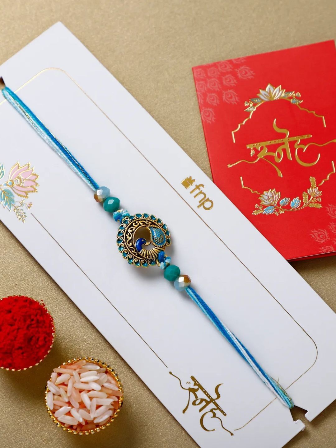 

fnp Jewel of the Sky Peacock Rakhi Traditional Kundan, Blue