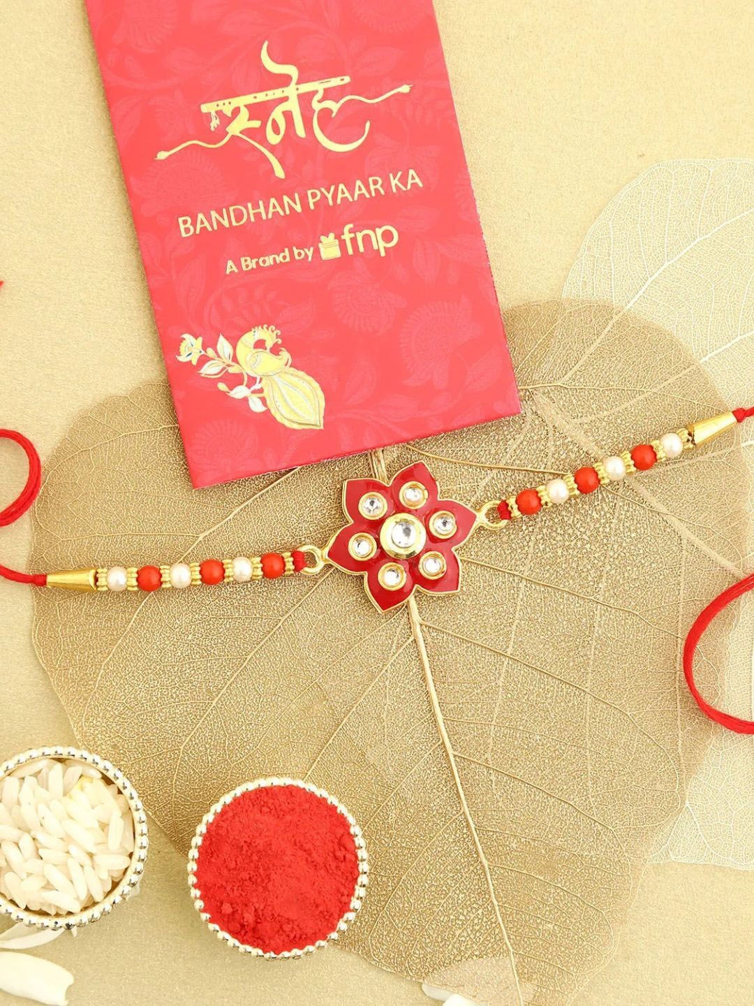 

fnp Pearls in a Burgundy Bloom Kundan Rakhi Bracelet Rakhis, Red