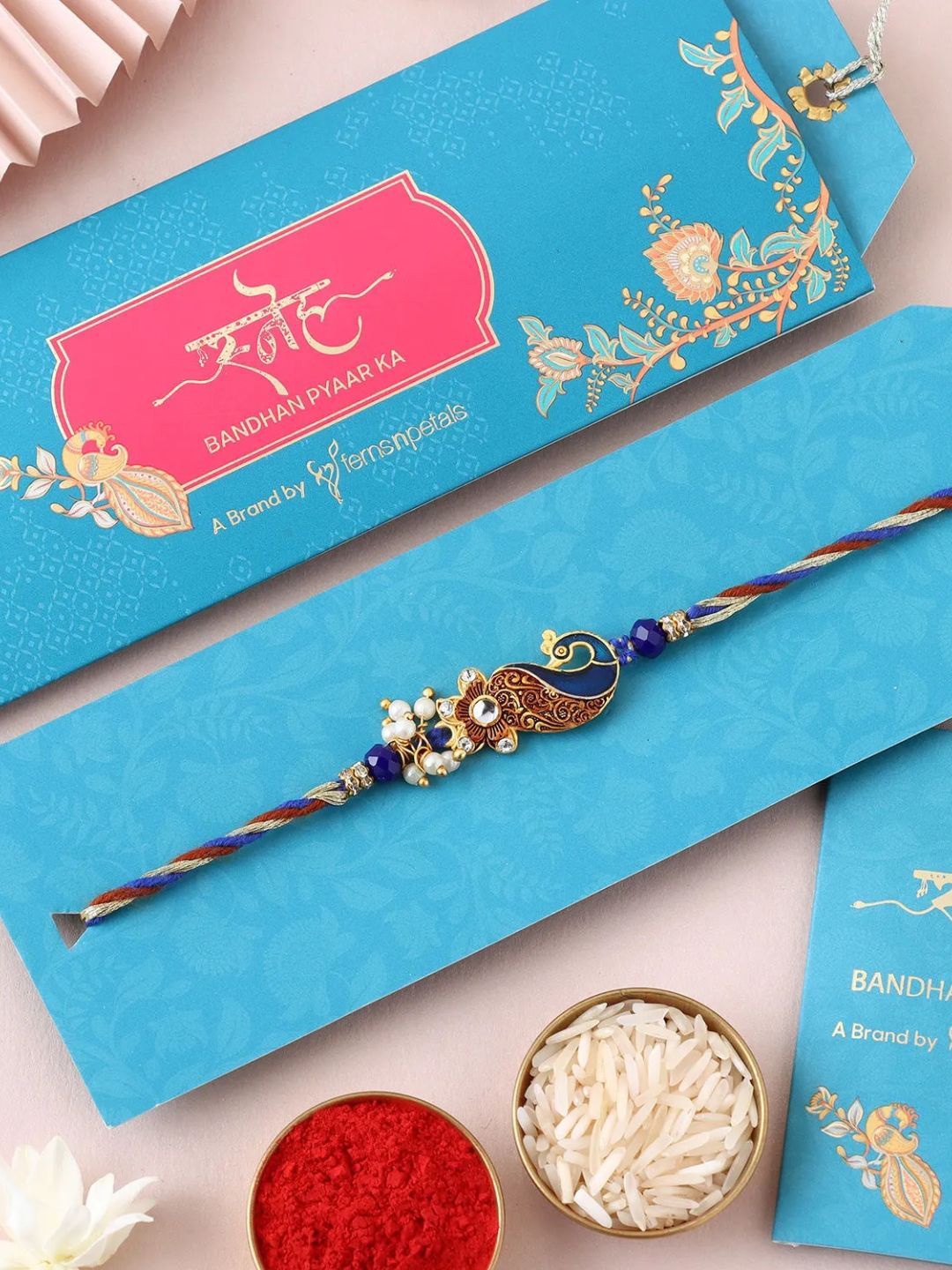

fnp Graceful Peacock Swirl Rakhi Traditional Kundan, Blue