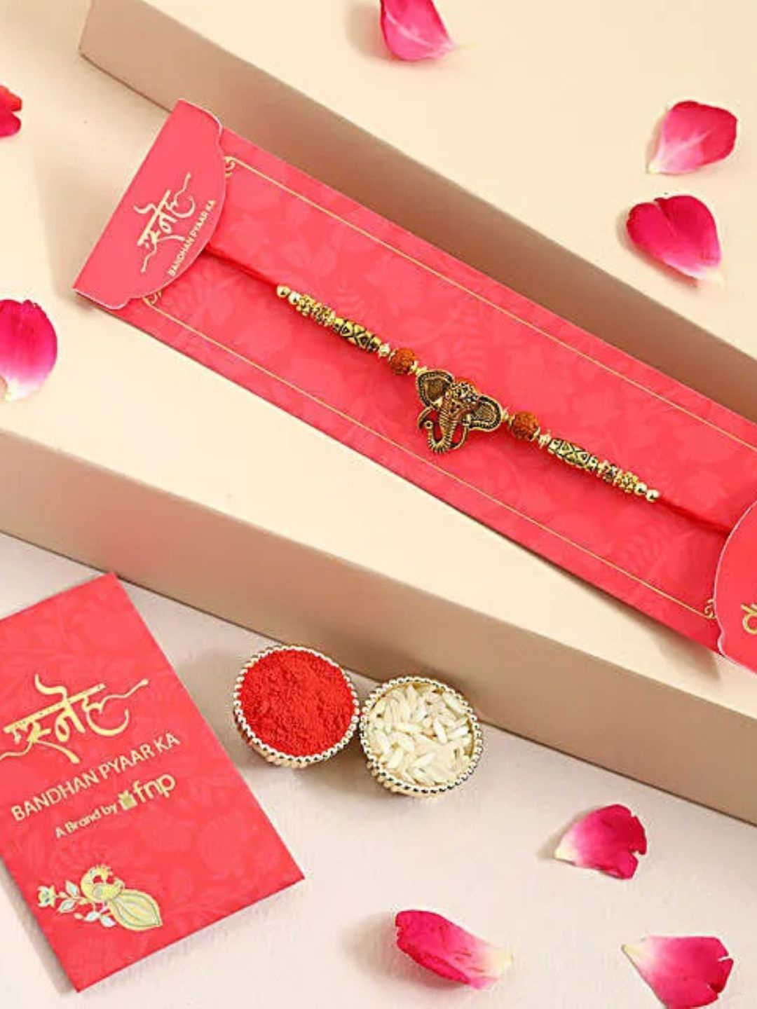 

fnp Sneh Gold N Red Ganesha Rudraksh Rakhi Magical Evil Eye