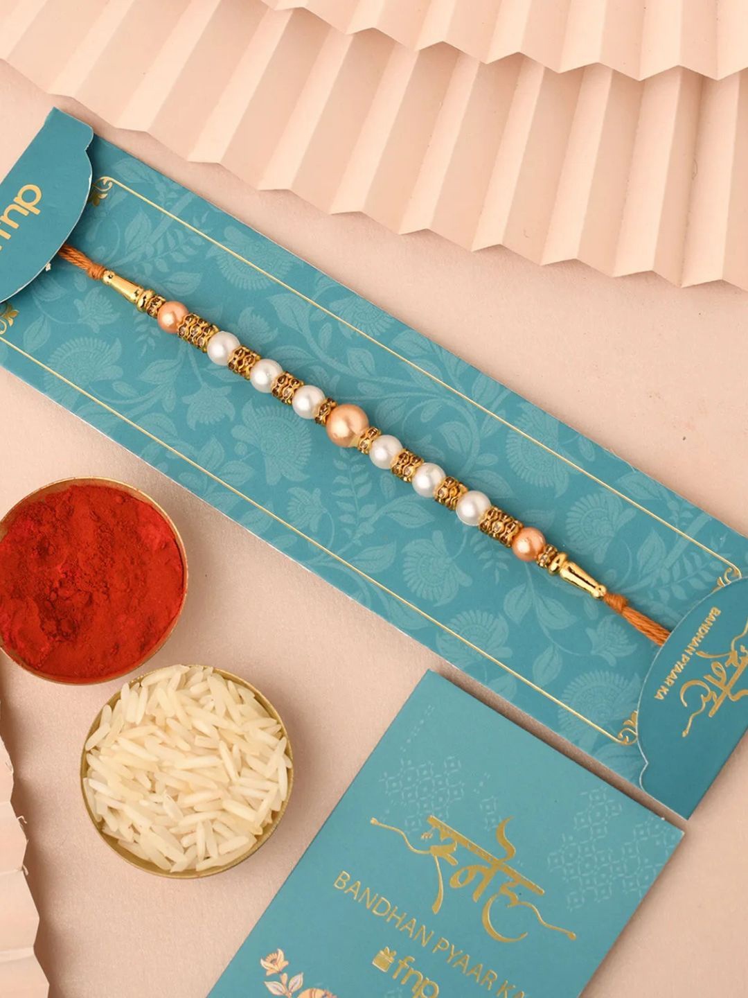 

fnp Dawn Rising Beads Rakhi Traditional Kundan, White