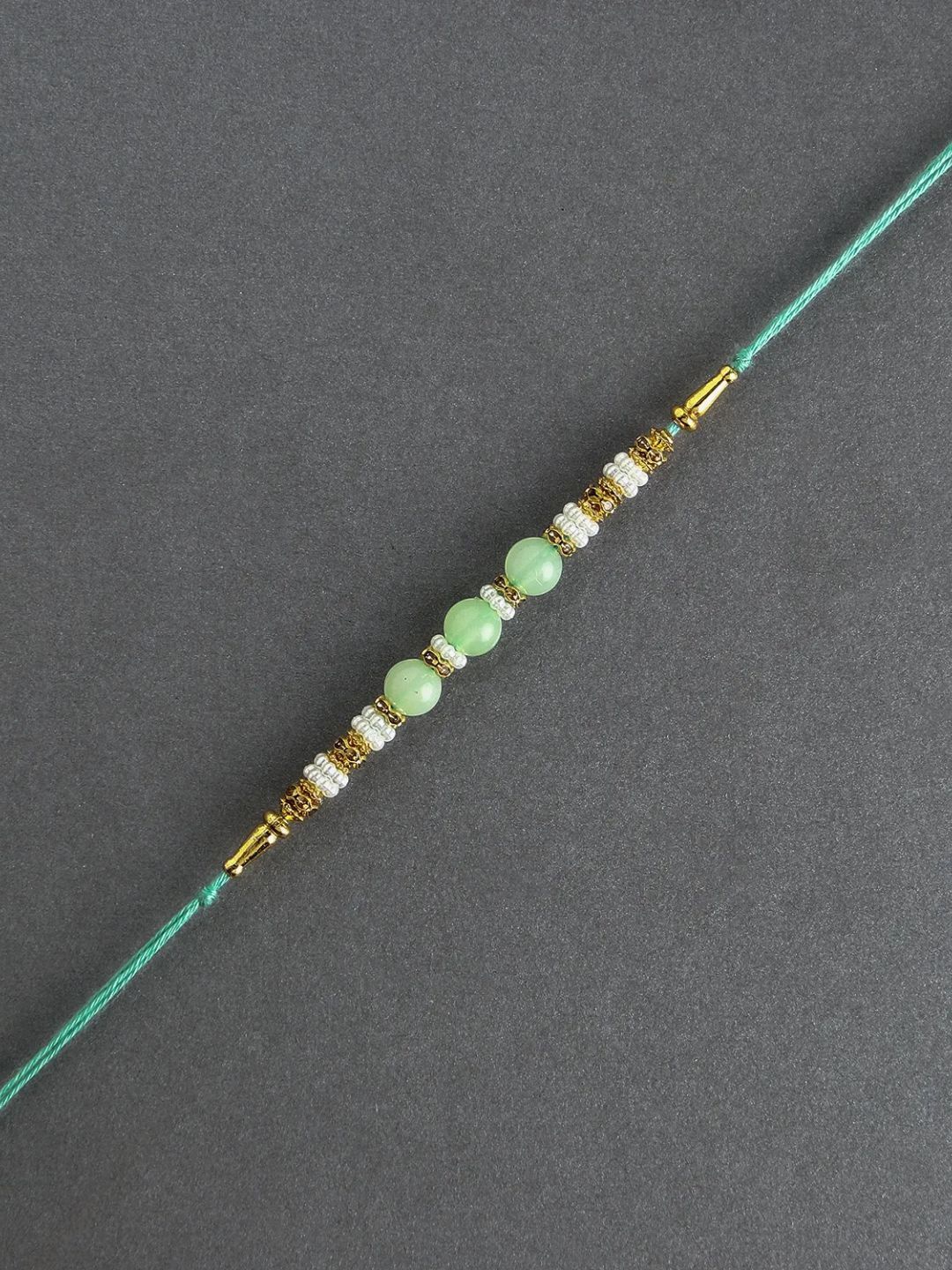 

fnp Graceful Pearl Ethnic Rakhi Green Traditional Kundan