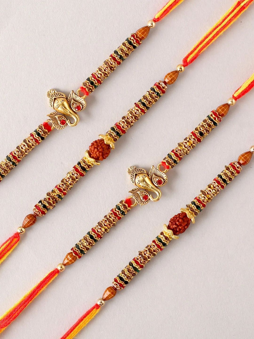 

fnp Ganesha and Rudraksha Set of 4 Blessed Rakhi Bracelet Rakhis, Gold