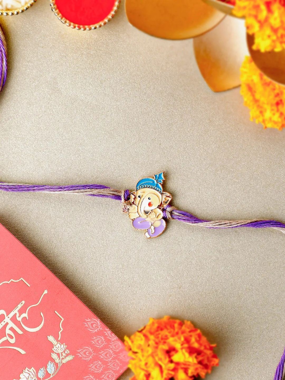 

fnp Bal Ganesha Cheerful Charm Rakhi Silver Selections, Purple