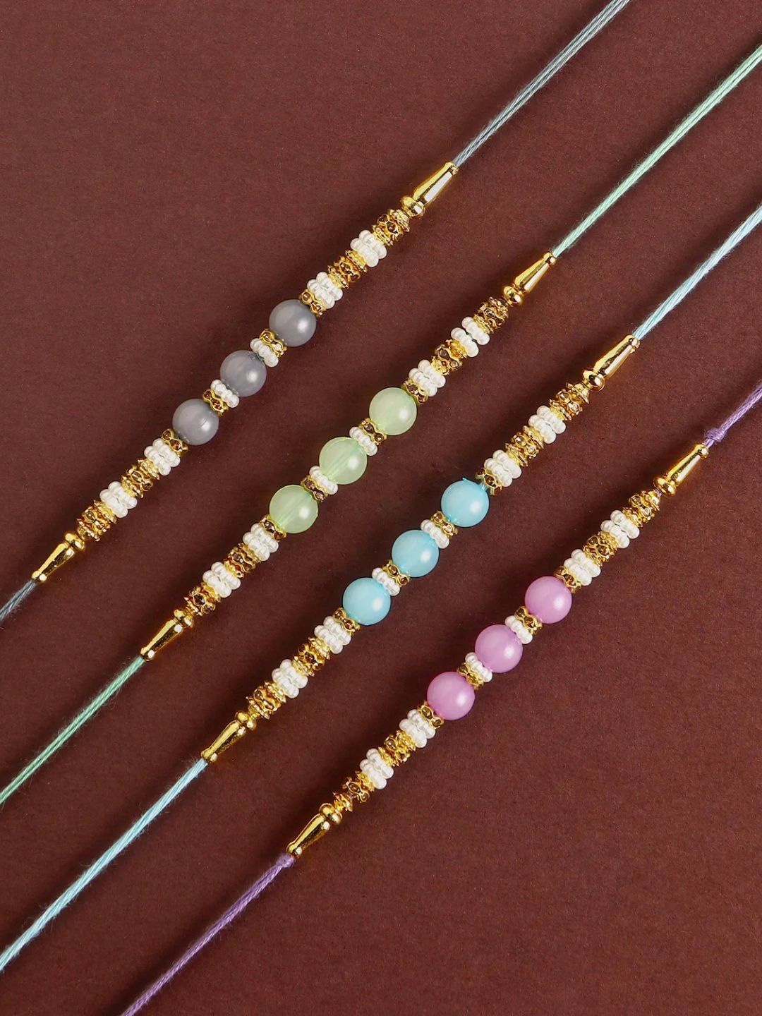 

fnp Zen Beadwork Rakhi Set of 2 Magical Evil Eye, Gold