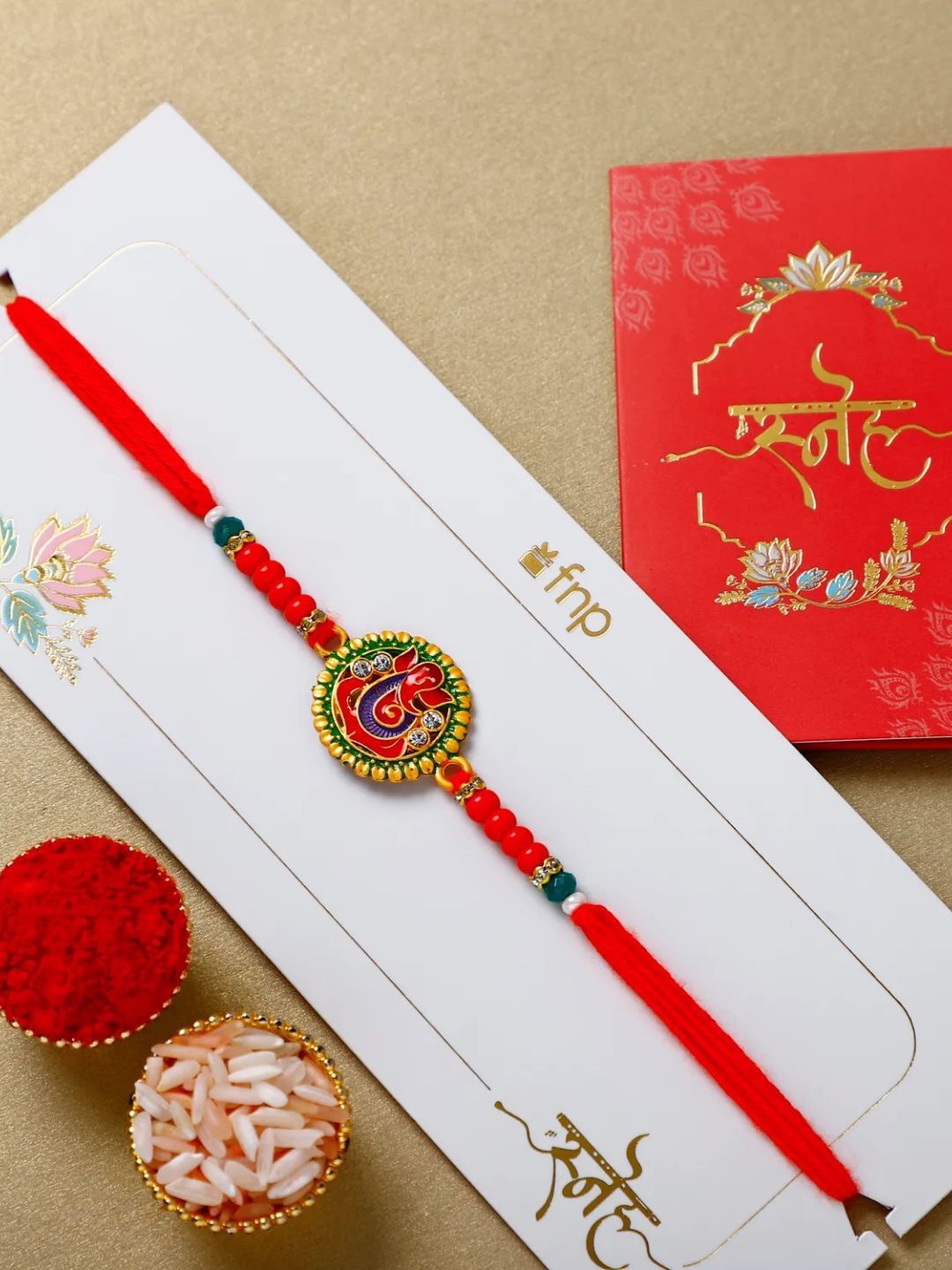 

fnp Enigmatic Ganesha Essence Rakhi Traditional Kundan, Red