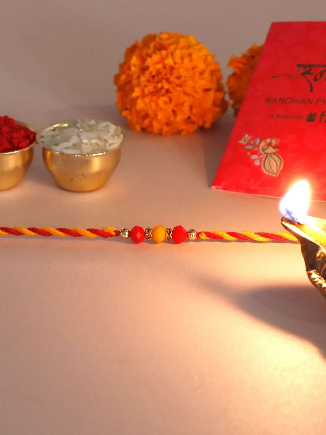 

fnp Mauli Harmony Rakhi Bhaiya-Bhabhi Rakhis, Red