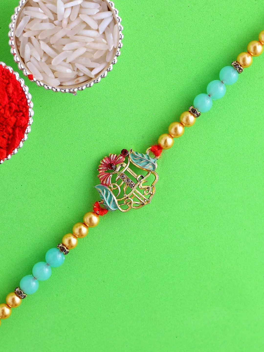 

fnp Auspicious Sai Rakhi American Diamond, Gold
