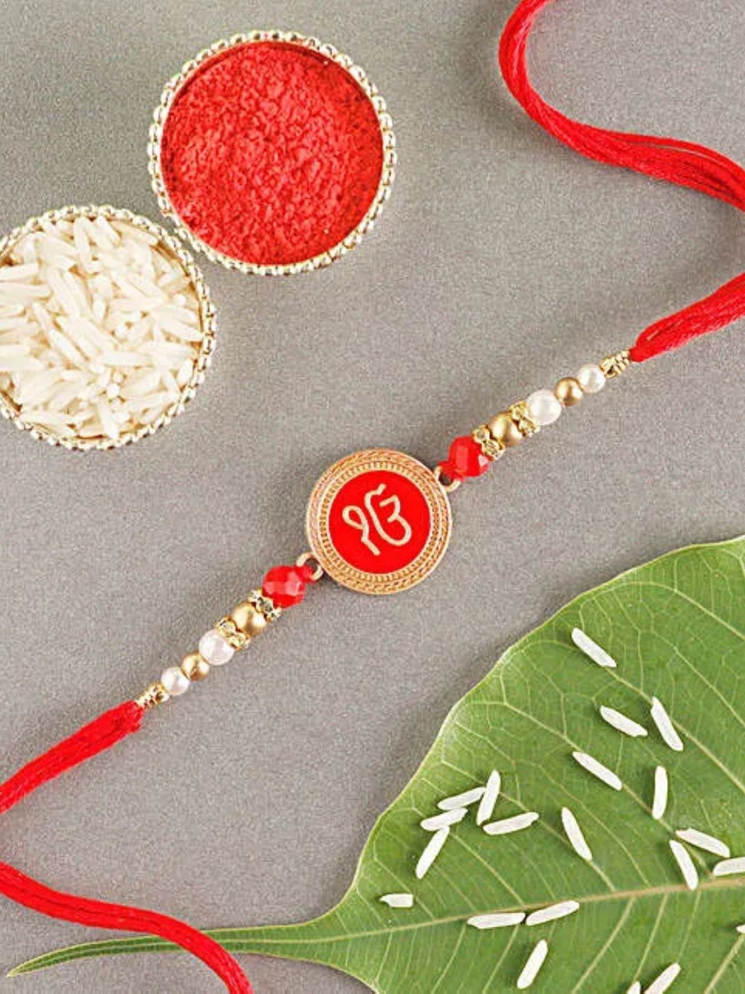 

fnp Sneh Red Onkar Blessings Rakhi American Diamond, Gold