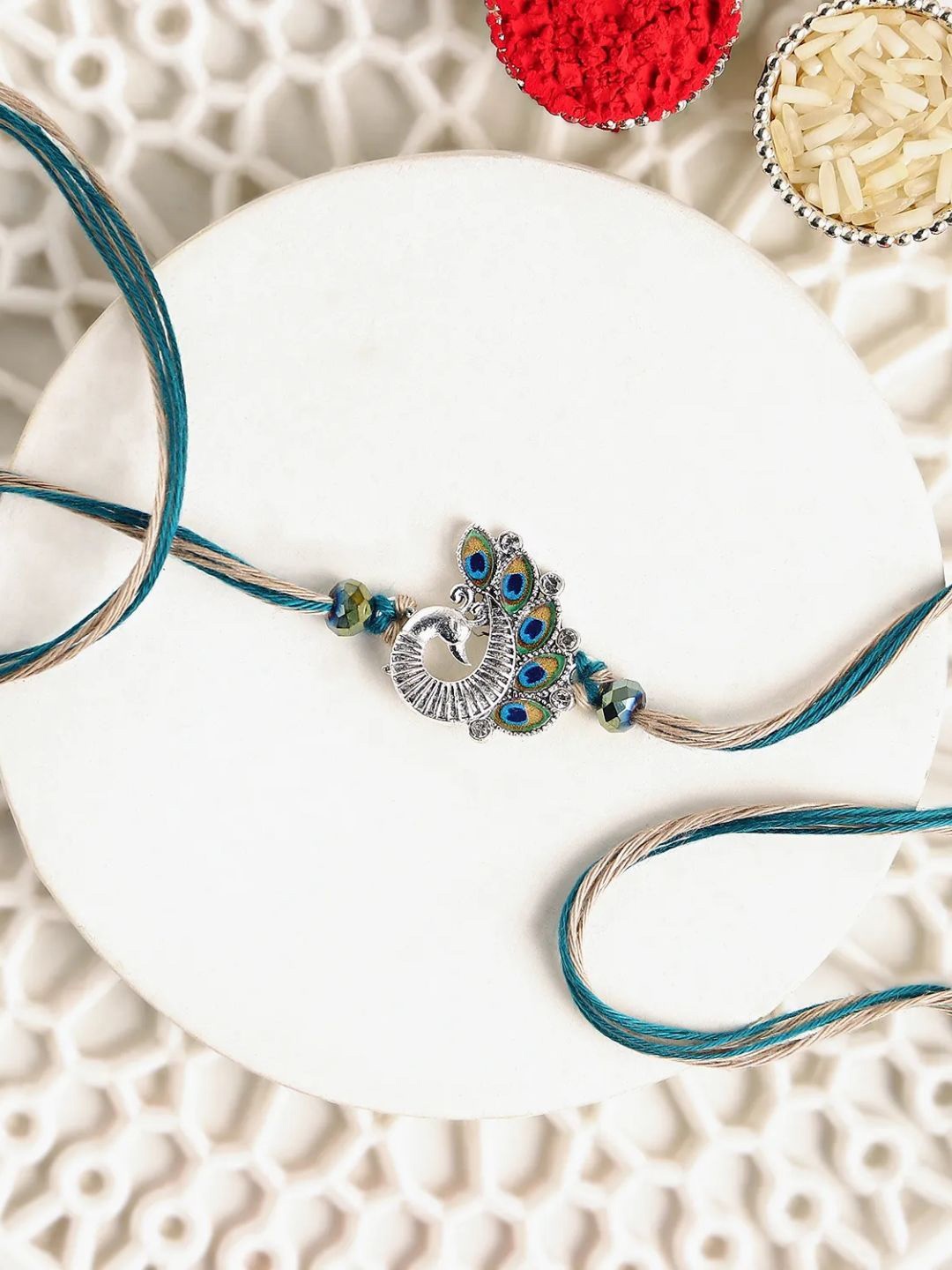 

fnp Sapphire Serenity Peacock Rakhi Magical Evil Eye, Blue