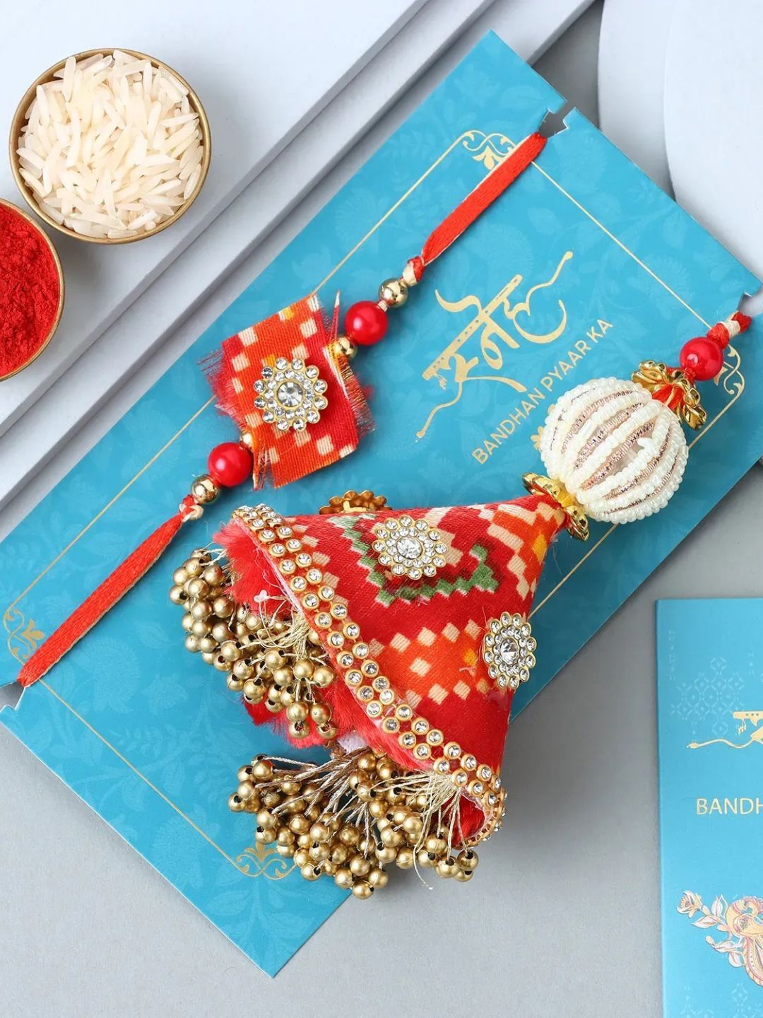 

fnp Eternal Unity Bandhani Lumba Rakhi Set Bhaiya-Bhabhi Rakhis, Red