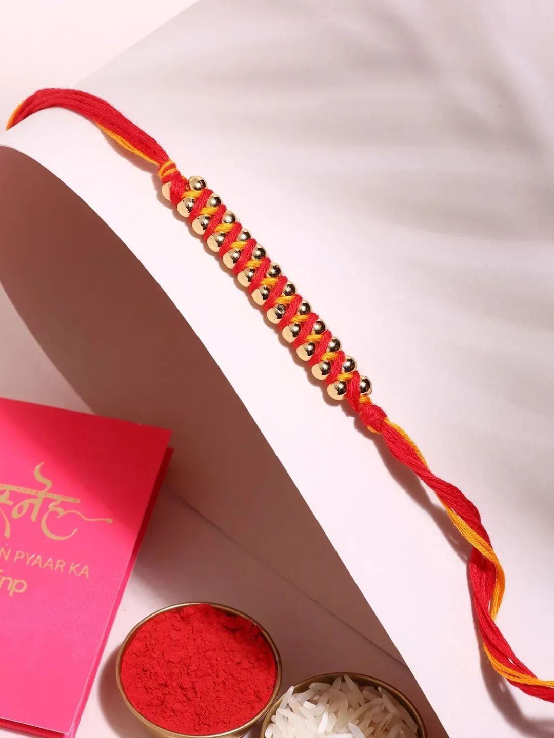 

fnp Colourful Bond Rakhi Beads N Mauli Blend American Diamond, Red