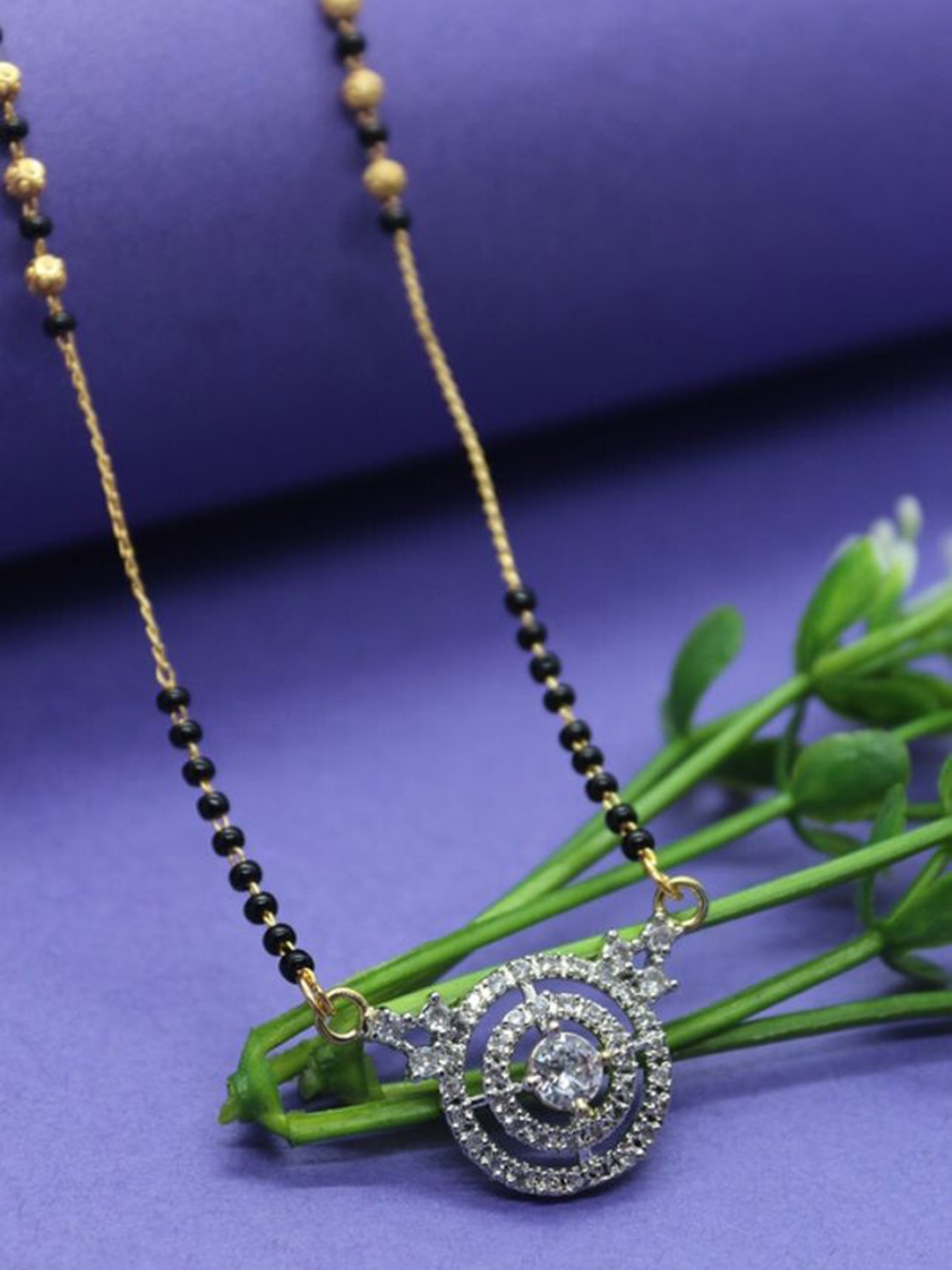 

Wynona Tanmaniya Gold-Plated Artificial Stones Studded & Beaded Mangalsutra