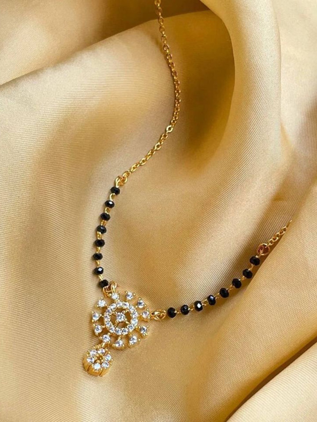 

Wynona Tanmaniya Gold-Plated Artificial Stones Studded & Beaded Short Mangalsutra