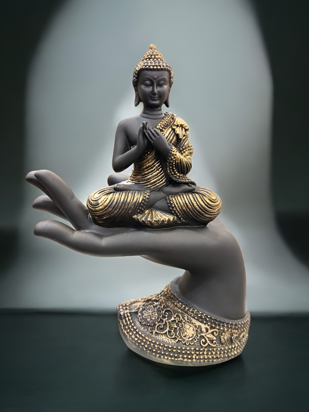 

SANKALAN CREATIONS Black Buddha Sitting On Palm With The Blessing Mudra Idol Showpiece