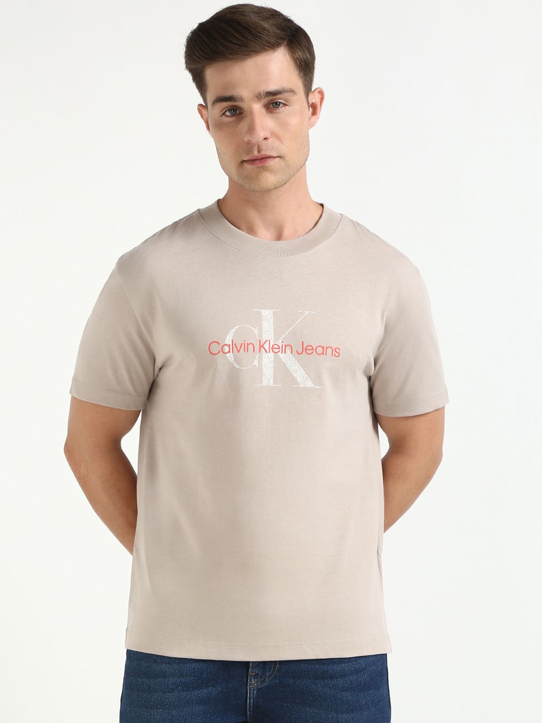 

Calvin Klein Jeans Men Typography Printed Round Neck Cotton T-shirt, Beige