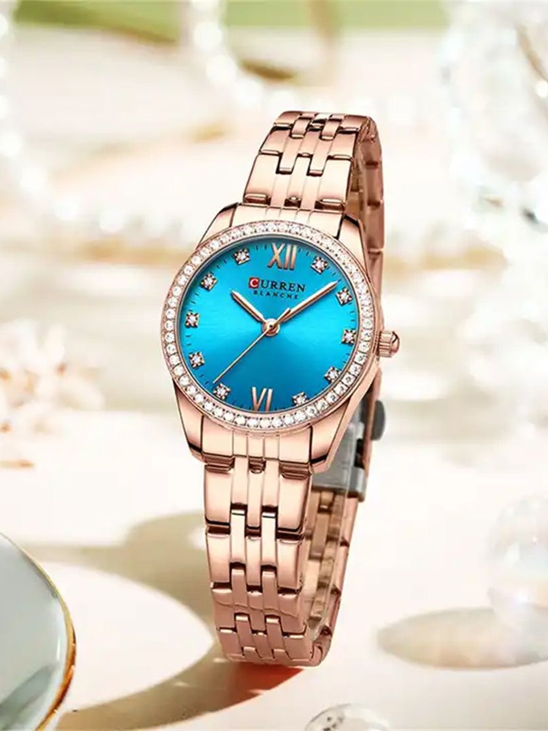 

Curren Women Brass Embellished Dial & Stainless Strap Steel Analogue Watch 9086-Rose-Blue