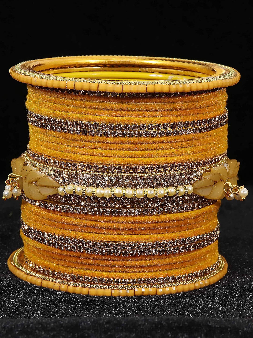 

Set of 40 Metal with Zircon Gemstone and Bells Latkan Linked Velvet Bangles, Yellow