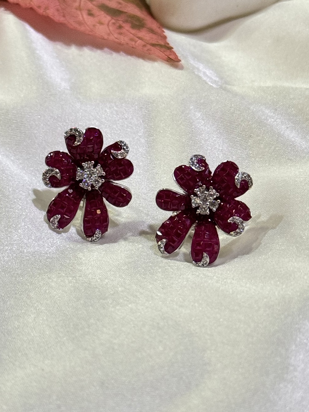 

The Jewellery Tale Silver-Plated American Diamond Stone Studded Star Shaped Floral Studs, Red