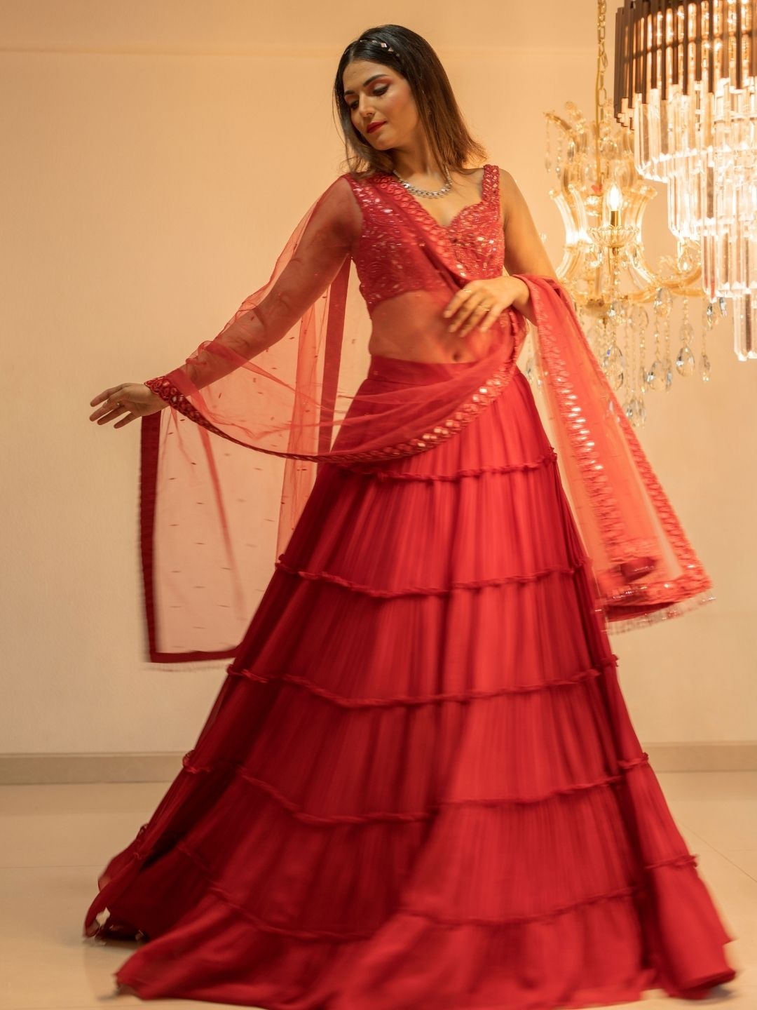 

Foram patel Red Tiered Mirror Work lehenga Set