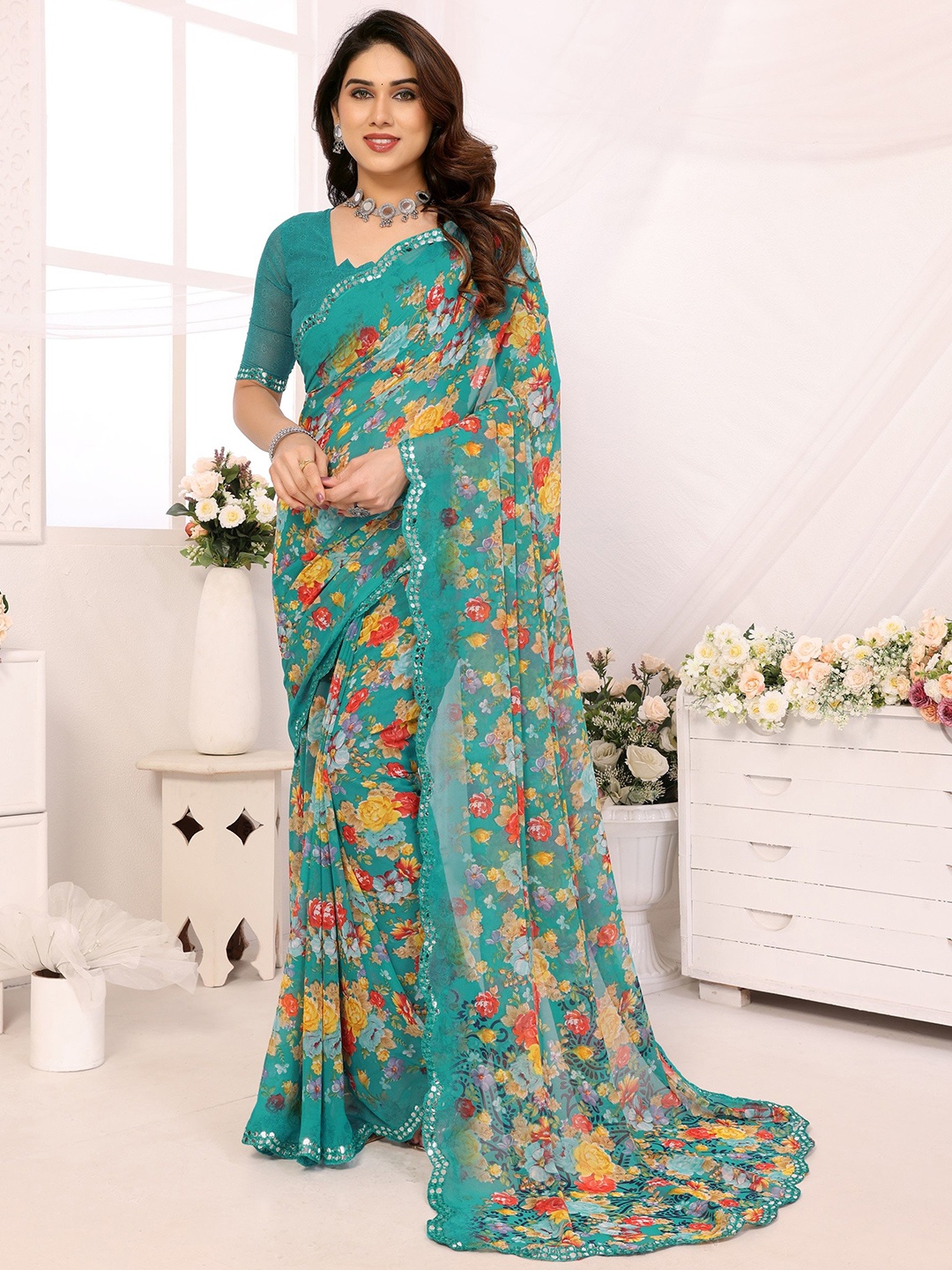 

Ambuja International Floral Printed Mirror Work Pure Georgette Saree, Teal