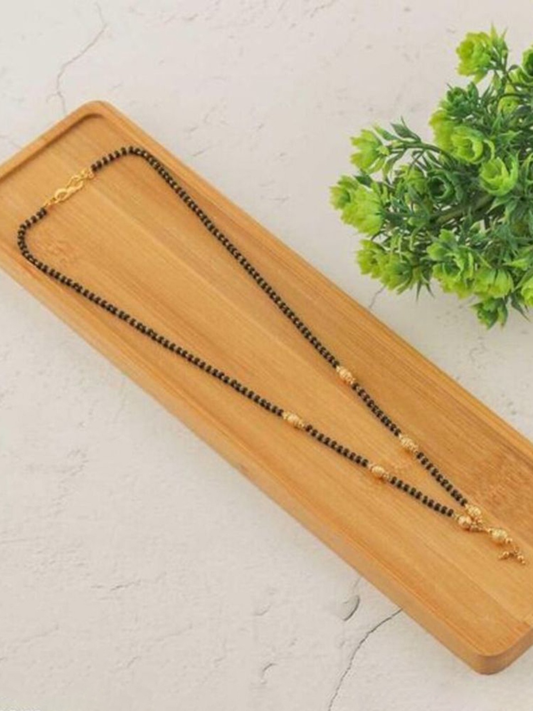

Wynona Tanmaniya Pack Of 2 Gold-Plated American Diamond Studded Mangalsutra