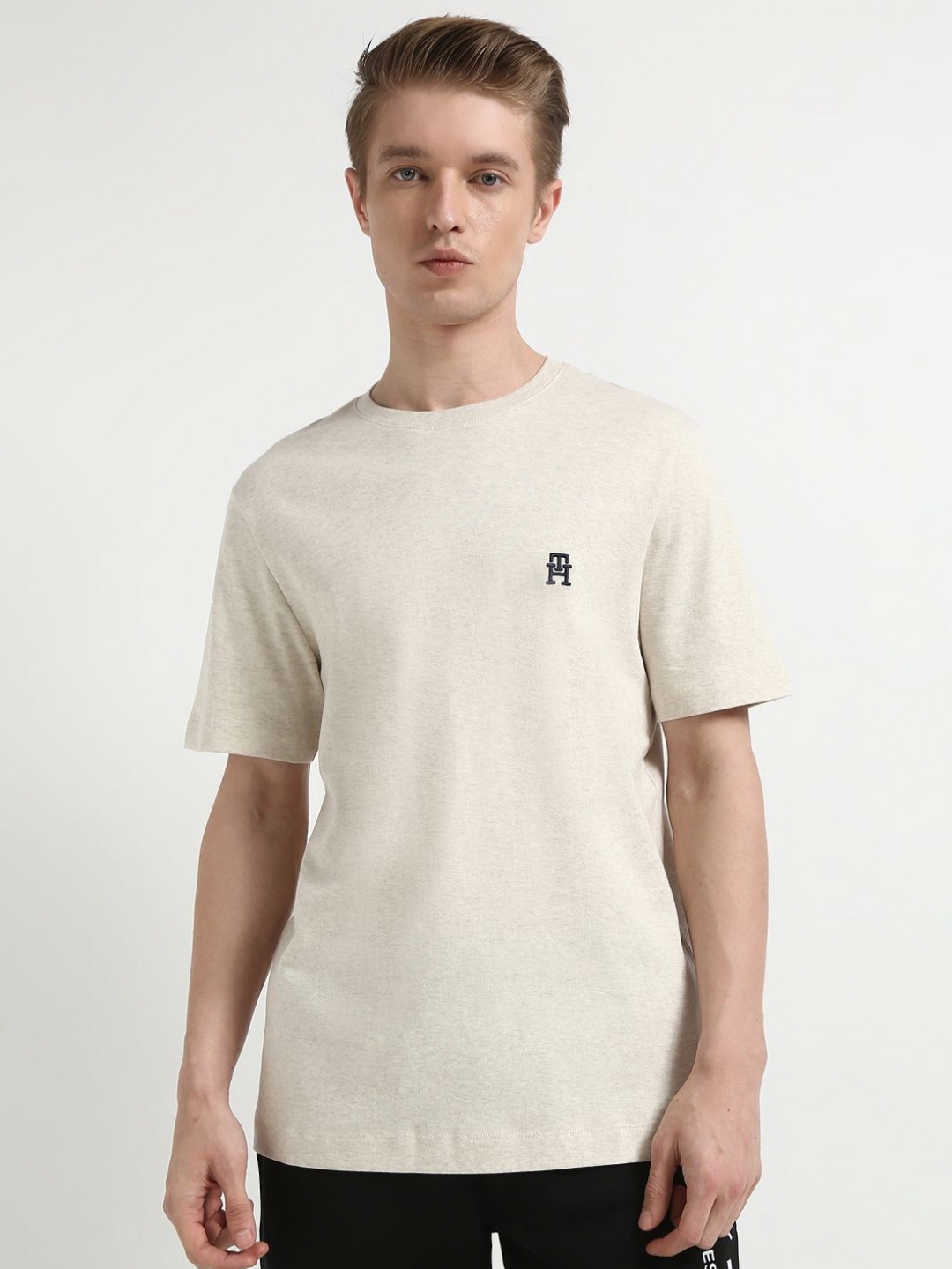 

Tommy Hilfiger Men Solid Round Neck Cotton T-shirt, Off white