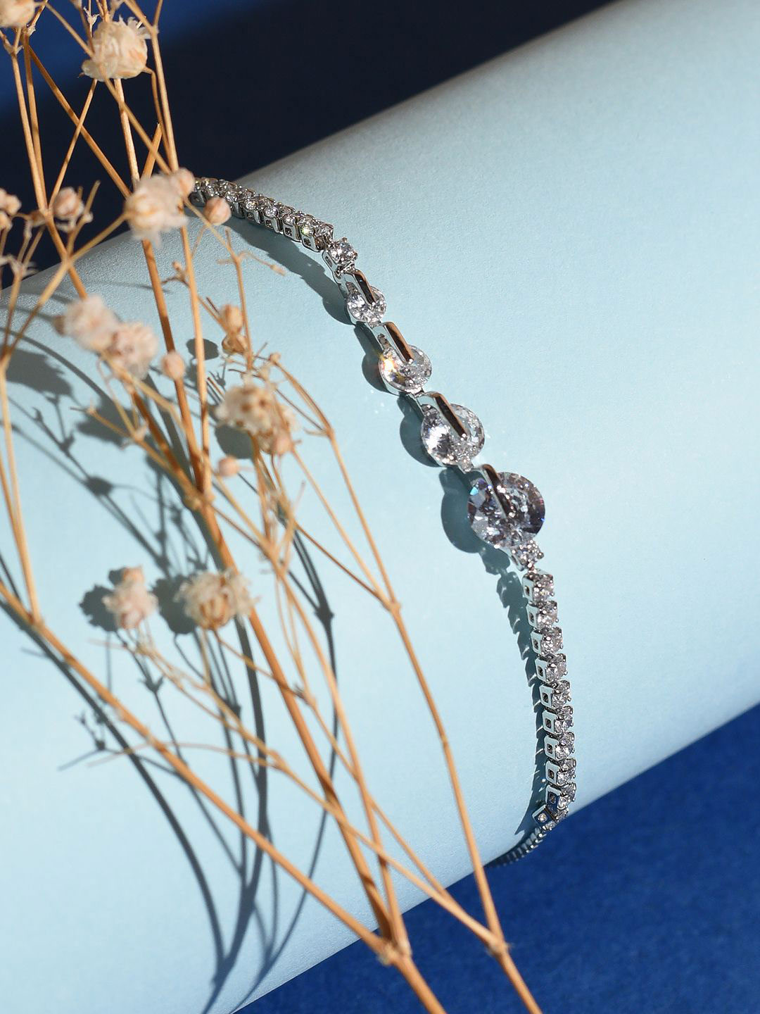 

XPNSV Silver-Plated American Diamond Graduated Studded Charm Bracelet