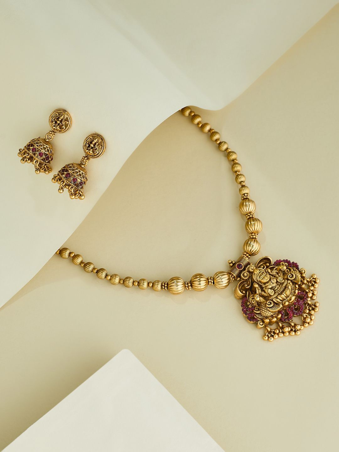 

Yinara Gold-Plated Stone-Studded Temple Antique Jewellery Set