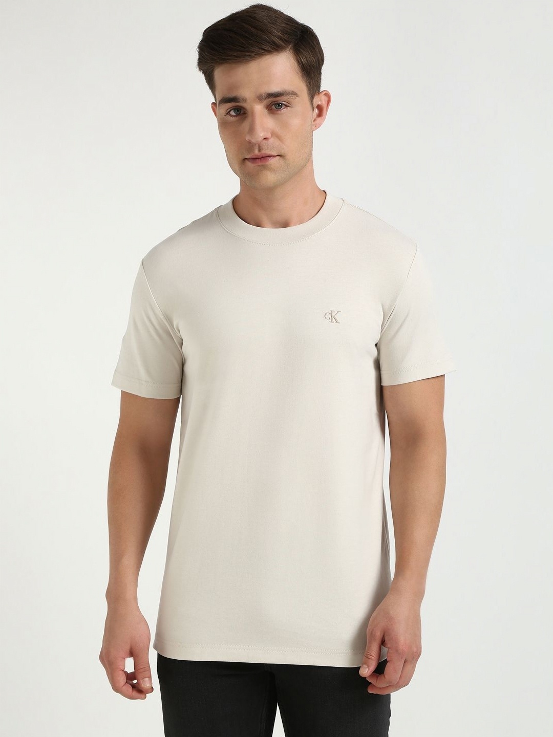 

Calvin Klein Jeans Men Solid Round Neck Cotton T-shirt, Off white