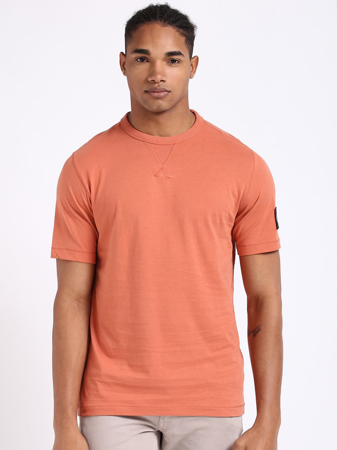 

Calvin Klein Jeans Men Solid Round Neck Cotton T-shirt, Peach