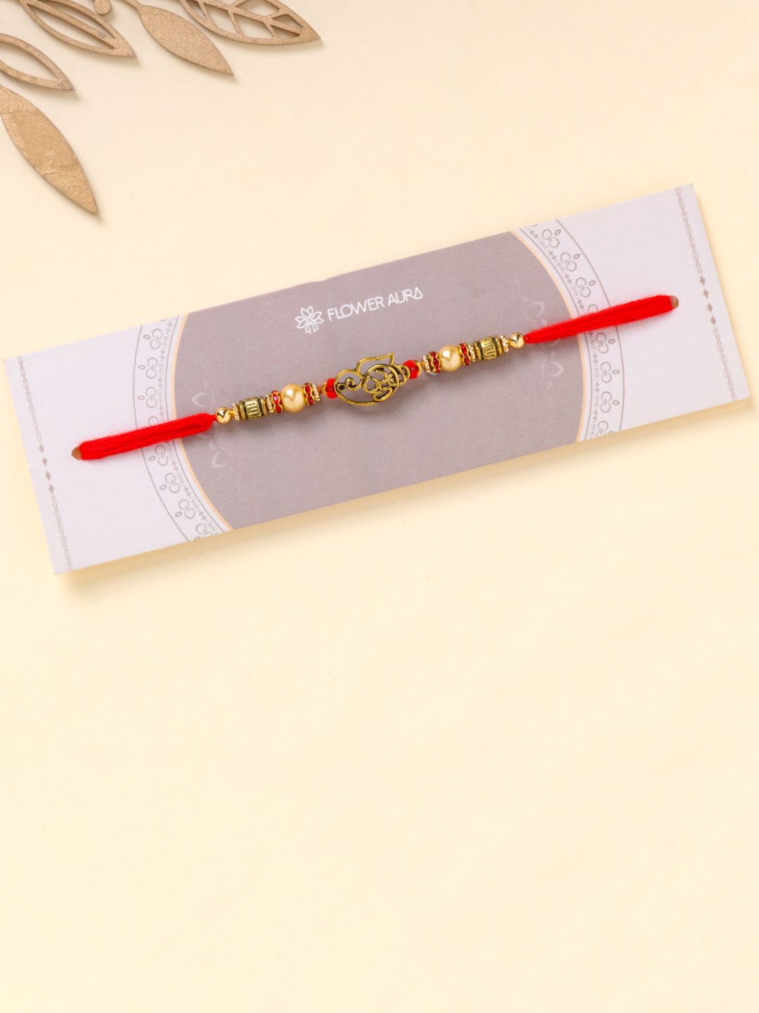 

Floweraura Unique Om Ganesha Beaded Thread Bracelet Rakhi with Roli Chawal, Gold